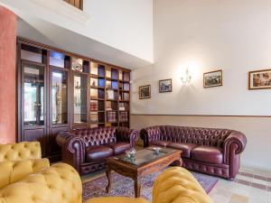 a living room with leather couches and a table at Holiday Home in Carlentini with Swimming Pool,Garden,Terrace in Agnone Bagni
