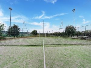 a tennis court with a net in the middle at Holiday Home in Carlentini with Swimming Pool,Garden,Terrace in Agnone Bagni