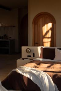 a bedroom with a large bed with a wooden headboard at Stone - Rare Earth Retreats in McLaren Vale