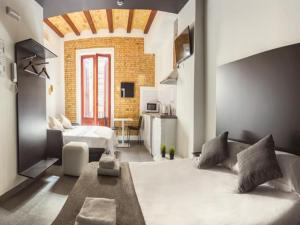a living room filled with furniture and a large window at Soho Valencia in Valencia
