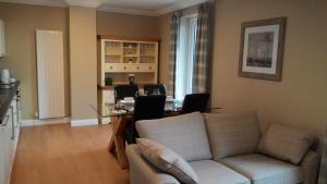 a living room with a couch and a table at Allt Nan Ros Apartments fort william in Onich