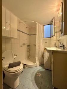 a bathroom with a toilet and a shower and a sink at Nagomi Centre Spot in Kavála +24 photos