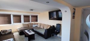 a living room with a couch and a table at Lux Maisonette in Chernomorets