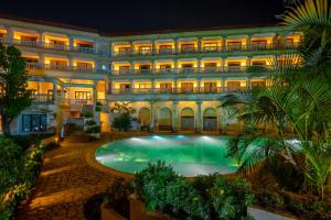 an exterior view of a hotel with a swimming pool at The Lagoona Resort in Lonavala