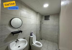 a bathroom with a sink and a toilet and a mirror at Harina Homestay At Sireh Residence near AEON MALL KOTA BHARU in Kota Bharu +19 photos