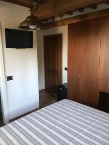 a bedroom with a bed and a flat screen tv at Bellavista Prile in Castiglione della Pescaia