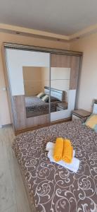 a bed with two yellow pillows and a large mirror at Lux Maisonette in Chernomorets +49 photos