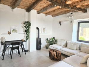 a living room with a couch and a table at Stone Villa at the Vrelo in Dobra Voda