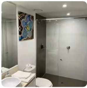 a bathroom with a toilet and a sink and a shower at 5 star 3 Bedroom Apt on Surfers Paradise Beach, Ocean views from every room in Gold Coast