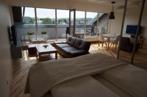 a living room with a couch and a table at Napoleon Hill Apartment in Kaunas