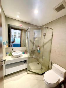 a bathroom with a shower and a toilet and a sink at Delux Studio In Vinhomes Green Bay Near WJ Marriott Hotel in Hanoi