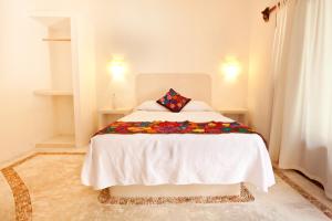 Postel nebo postele na pokoji v ubytování Casa Iguana Holbox - Beachfront Hotel