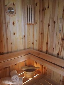 a bathroom with a toilet in a wooden wall at House therapy in Sremčica