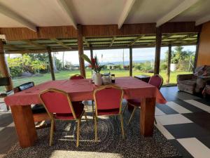 a dining room with a red table and chairs at AerowView Home Retreat in Matei