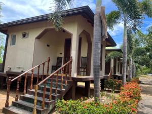 a house with a staircase leading to the front door at Sunrise Cabanas Arugam Bay in Arugam Bay