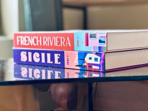 a stack of books sitting on top of a table at Le George Ville in Nice