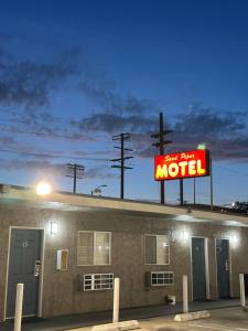 a motel sign on the roof of a building at Sand Piper Motel - Los Angeles in Los Angeles
