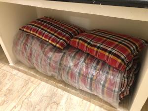 two pillows sitting on the floor in a closet at Chinmayi Guest Suite in Avanigadda