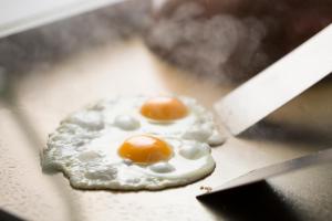 two fried eggs on top of a pizza at ANA Holiday Inn Kanazawa Sky by IHG in Kanazawa