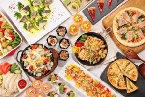a table with many different types of food on it at ANA Holiday Inn Kanazawa Sky by IHG in Kanazawa