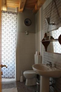 a bathroom with a toilet and a sink at B&B Alla Santella in Calvagese della Riviera