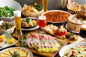 a table with many different types of food and drinks at ANA Holiday Inn Kanazawa Sky by IHG in Kanazawa