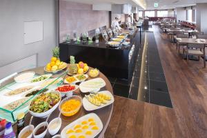a buffet line with plates of food in a restaurant at ANA Holiday Inn Kanazawa Sky by IHG in Kanazawa