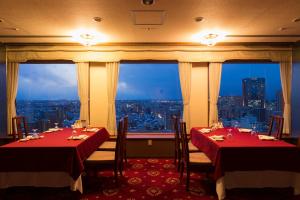a restaurant with two tables and a view of the city at ANA Holiday Inn Kanazawa Sky by IHG in Kanazawa