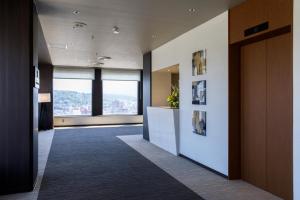 an office lobby with a view of a city at ANA Holiday Inn Kanazawa Sky by IHG in Kanazawa