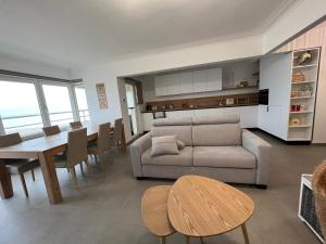 a living room with a couch and a table at En Bord de Mer in Middelkerke