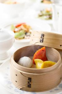 a wooden bowl of food on a table at ANA Holiday Inn Kanazawa Sky by IHG in Kanazawa