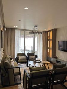 a living room with a couch and chairs and a table at The Erina House in Darjeeling
