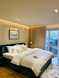 a bedroom with a large bed and a balcony at The Erina House in Darjeeling