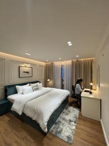 a woman sitting at a desk in a hotel room at The Erina House in Darjeeling