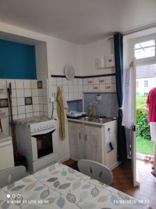 a kitchen with a sink and a stove at Maison de vacances individuelle toute équipée in Dampierre-sous-Bouhy +5 photos