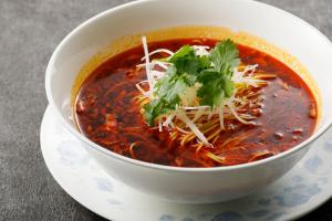 a bowl of soup on a plate on a table at ANA Holiday Inn Kanazawa Sky by IHG in Kanazawa