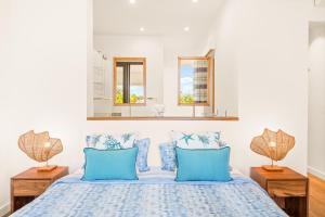 a bedroom with a blue bed with blue pillows at Bluepearl, Sileview Residence in Rivière Noire +23 photos