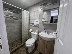a bathroom with a toilet and a sink at Casa Bella in Eforie Sud