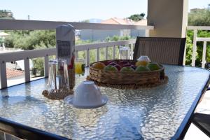 a glass table with a basket of fruit on a balcony at Villa Miranda in Keri