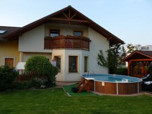 a house with a pool in front of it at Privat INKA in Liptovský Mikuláš