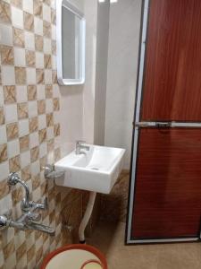 a bathroom with a sink and a toilet at Via Sagar Residency in Navi Mumbai