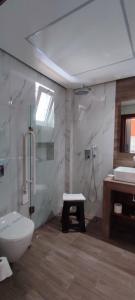 a bathroom with a toilet and a sink at Amalia in Paleo Tsifliki