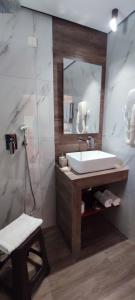 a bathroom with a sink and a mirror at Amalia in Paleo Tsifliki