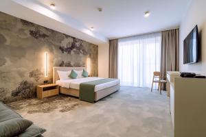 Postel nebo postele na pokoji v ubytování ARIS Boutique Hotel & SPA + 132 fotografií