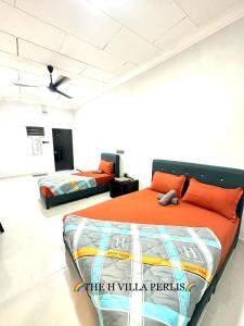 a bedroom with two beds in a room at The H Villa Perlis in Kangar
