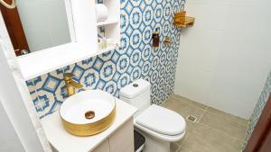 a bathroom with a toilet and a sink at CASA PLAYA JAMES in La Boquilla +12 photos
