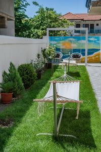 a hammock sitting on the grass in a yard at Vila Amir Vama Veche in Vama Veche