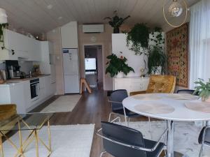 a kitchen and living room with a table and chairs at Tiny house in Hailuoto in Hailuoto