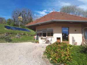 a small house on a gravel road next to a field at Belltent La Jonquille in Hurecourt
