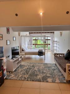 a large living room with a bed and a couch at Goldensun Resort Studio in Diani Beach